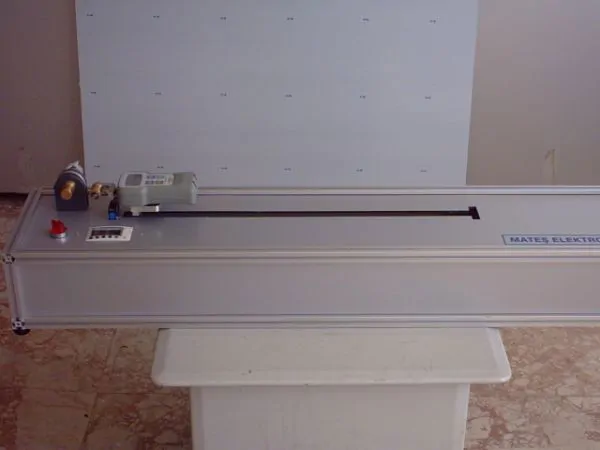 Tension test machine for determining the breaking strength and elongation of condoms.