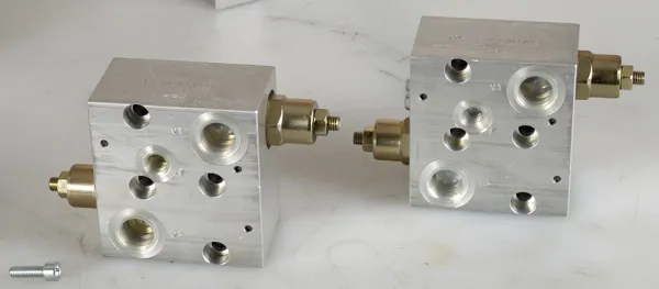 Engine-mounted counterbalance valves with brake release mechanism.